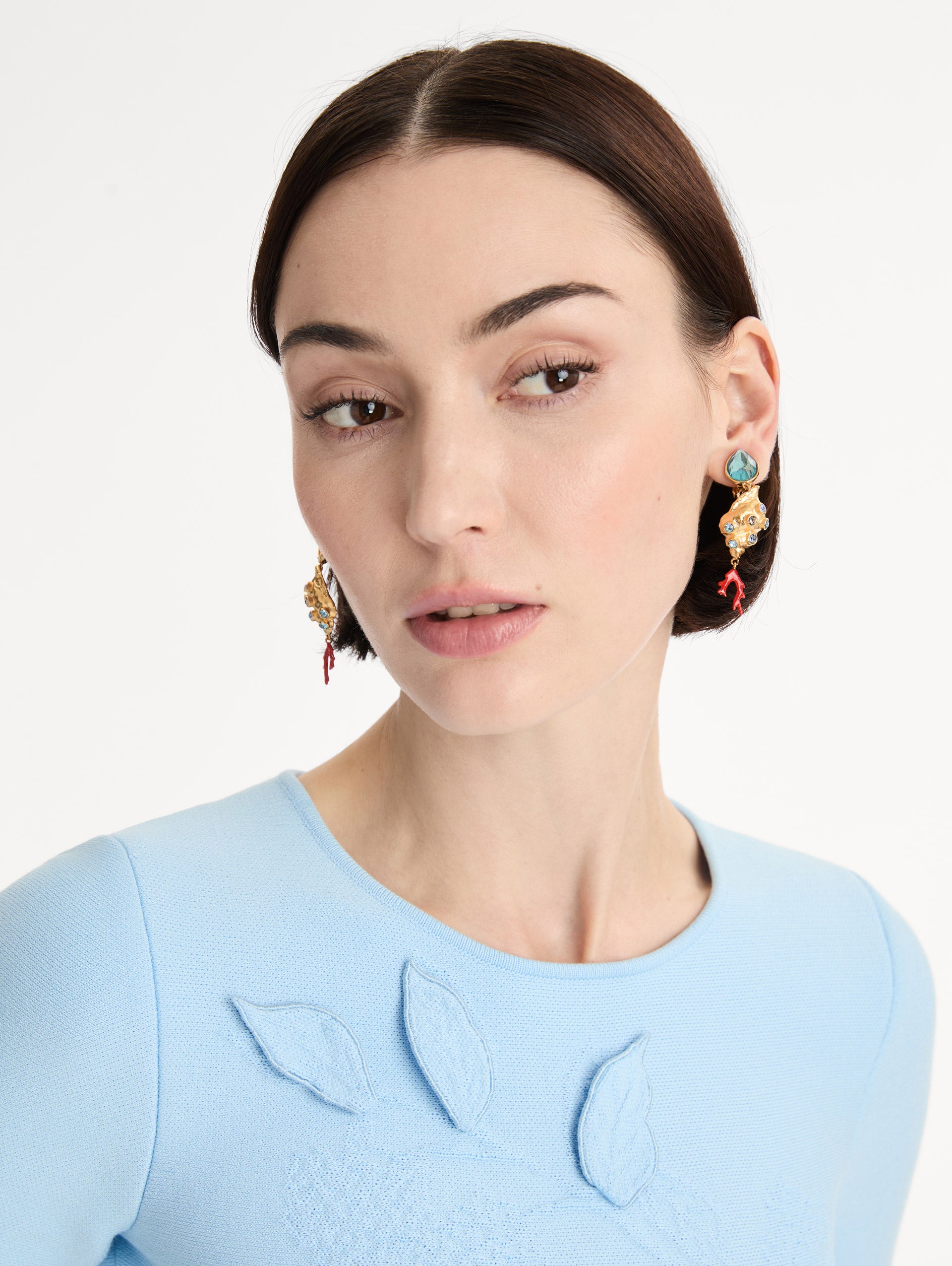 Gold Mixed Seashell Drop Clip-On Earrings with blue crystal accents, asymmetrical gemstone tops, and red coral-inspired dangle details. Front View.