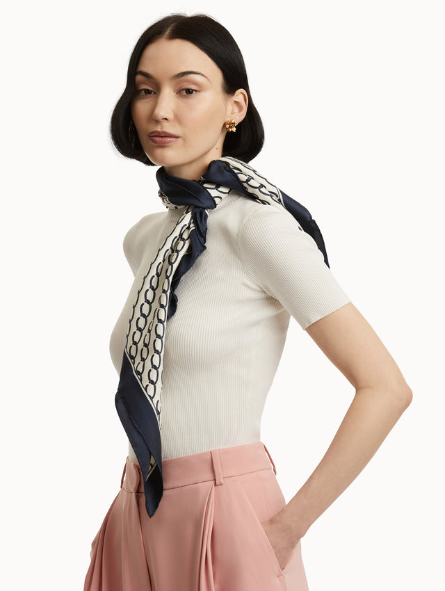 Oscar Chain-Link Silk Scarf in Navy and Ivory Paired with White Top and Pink Pants Side View
