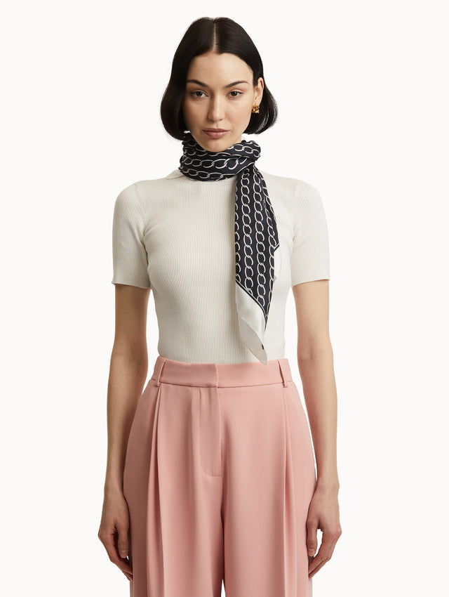 Oscar Chain-Link Silk Scarf in Navy and Ivory Paired with White Top and Pink Pants Front View