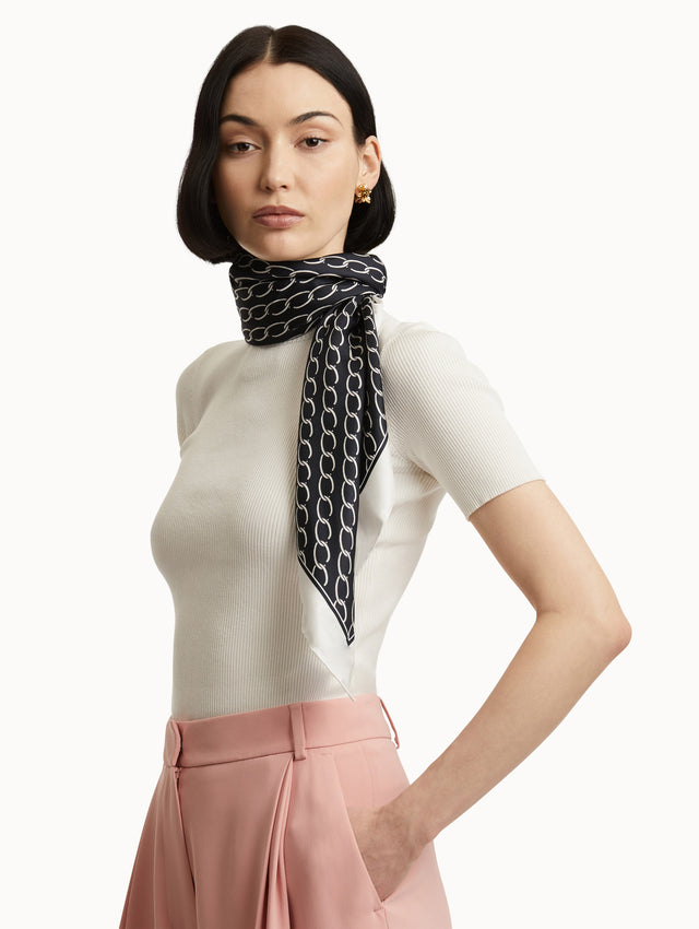 Oscar Chain-Link Silk Scarf in Navy and Ivory Paired with White Top and Pink Pants Side View