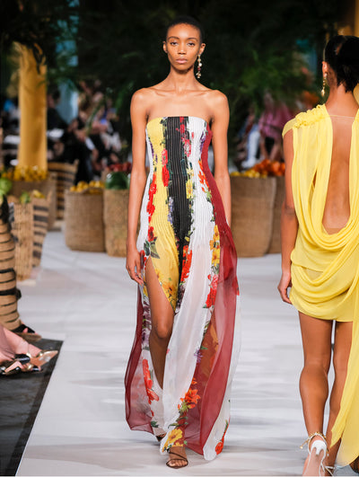 A model wears a multicolor floral printed striped gown