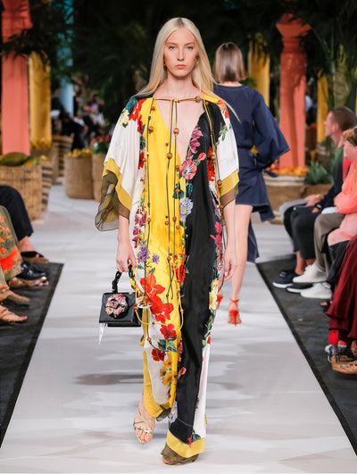 A model wears a multicolor floral printed caftan with string detailing