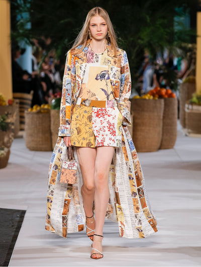 A model wears a floral printed coat with matching top and shirt