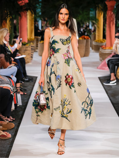 A model wears a khaki dress with flowers printed in vivid color