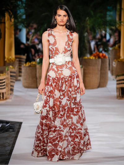 A model wears a red flower printed gown with white belt